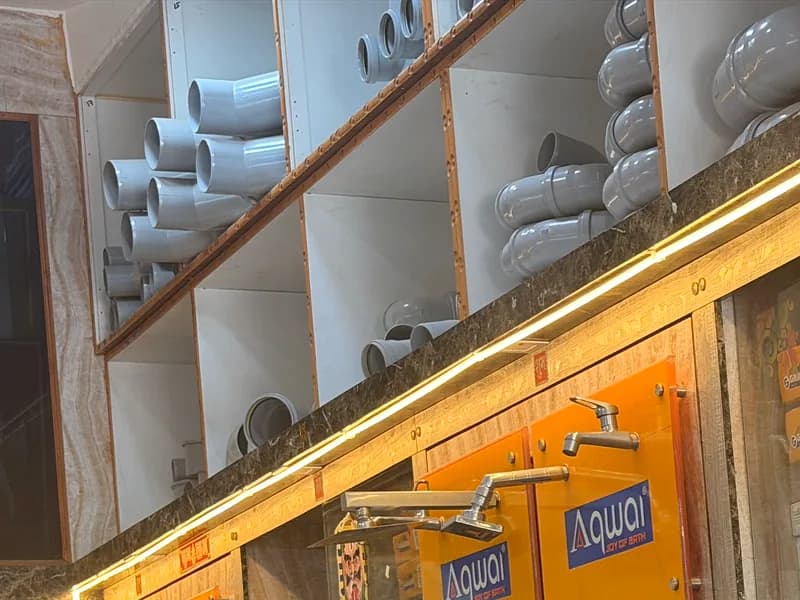 Shelves of grey PVC and SWR pipe fittings stacked by size